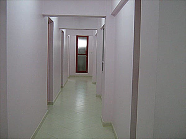 Long tiled corridor inside the clinic on the 9th floor